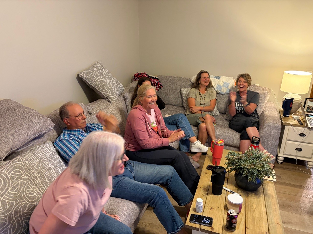 Group laughing together on the couch