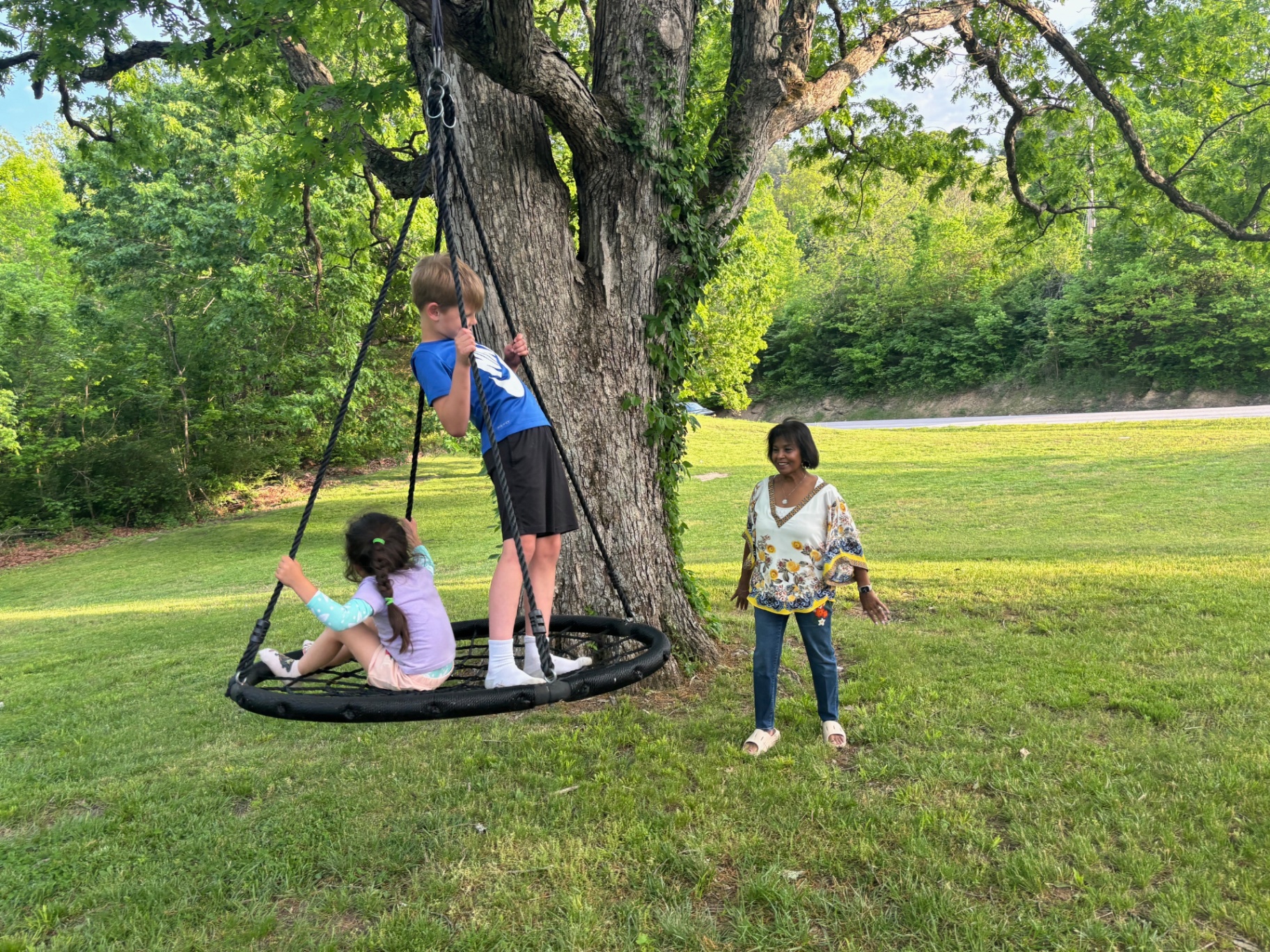 Kids on a tree swing while group meets